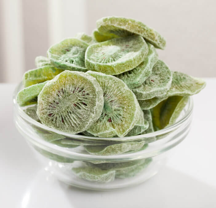 Natural dehydrated kiwi slices without sweeteners or preservatives in bowl. Healthy vitamin snack