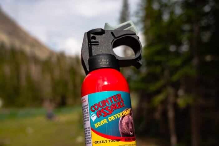 buffalo, United States – June 16, 2021: A hand holding a bear spray in the mountains