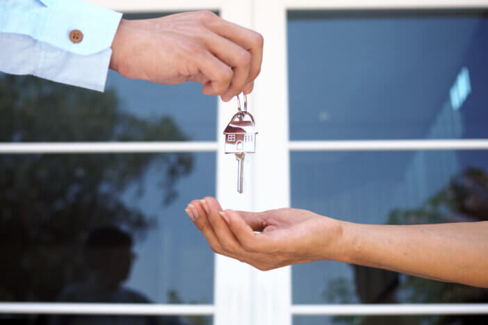 lease, rental and selling home. Real estate agent manager smile holding key for new owner. rent house, Sales, loan credit financial, insurance, Seller, dealer, installment, buy, sell, move in