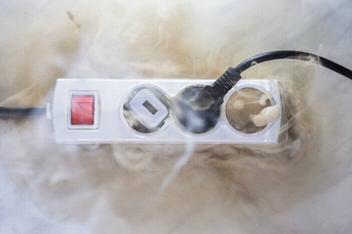 Failure caused by burning of the wire cable and socket outlet plug in the house, blurred photo, concept blurred background, selective focus.