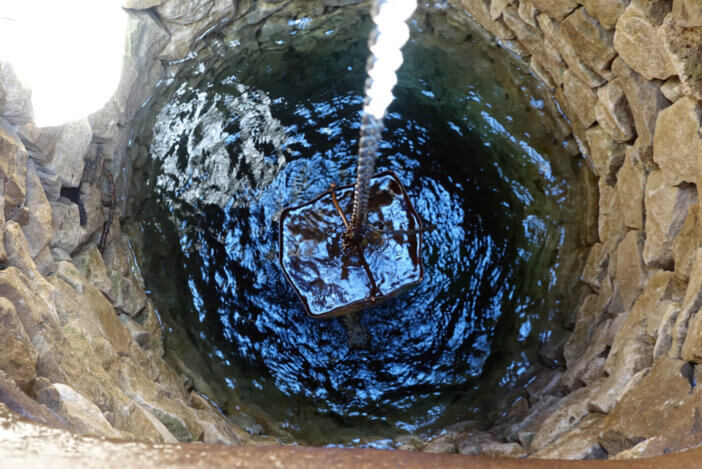 Iron bucket with water well