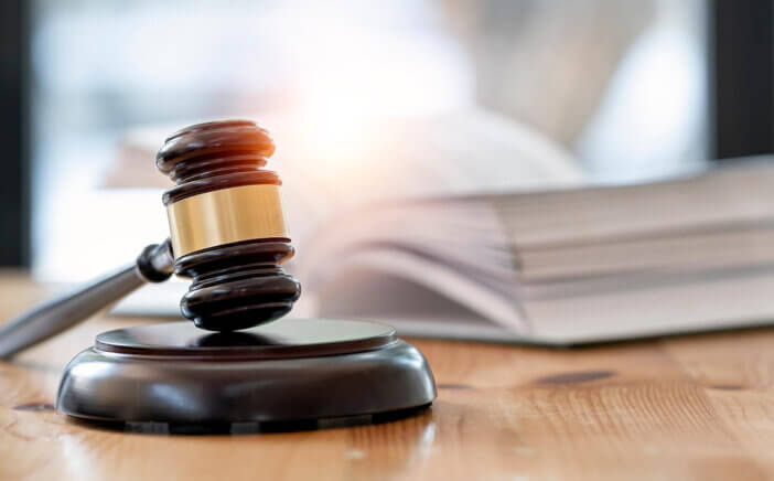 Wooden brown judge gavel on the table, copy space, banner background.