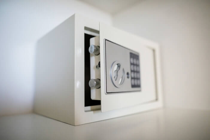 Metal safe inside an empty wooden closet in a hotel room