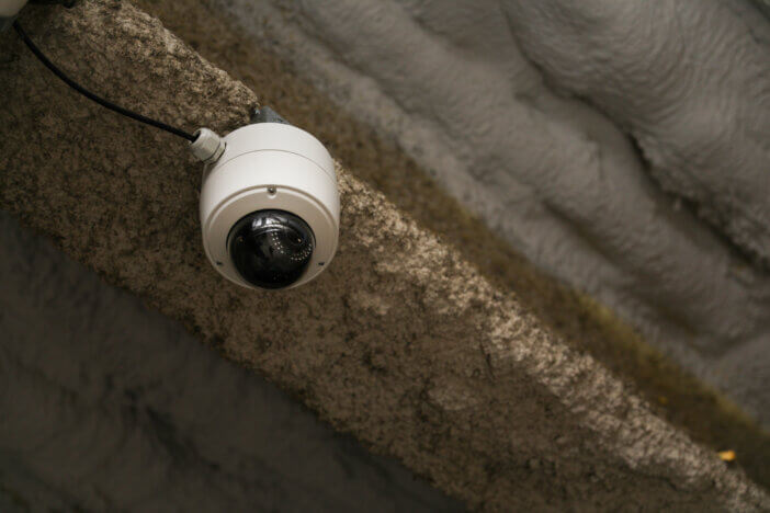 Security camera embodies vigilance, modern surveillance, privacy concerns, and a watchful society