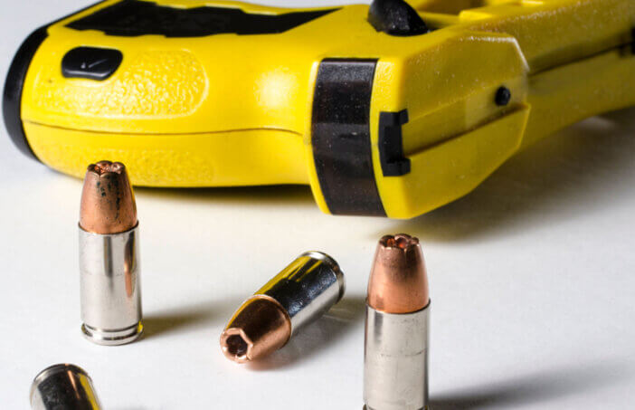 a close up of a police stun gun and bullets.