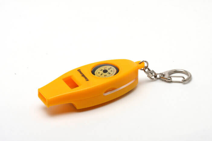 Plastic emergency whistle on white background.