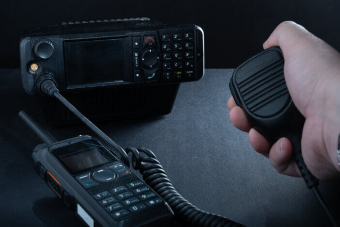 Helsinki / Finland - JANUARY 3, 2022: Closeup of pair of mobile two-way radios for Amateur radio operators against dark background.