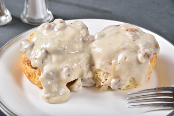 Close up of fresh homemade biscuits with country gravy and sausage bits