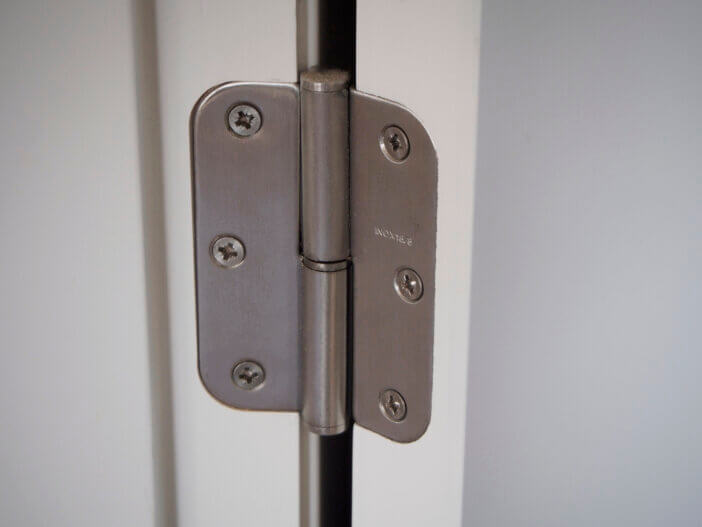 A hinge in the white door