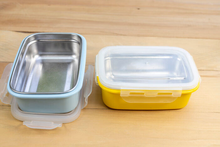 Metal empty stillness steel lunch boxes with on a wooden background