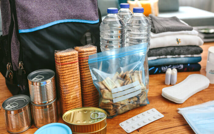 Emergency backpack equipment organized on the table in the living room