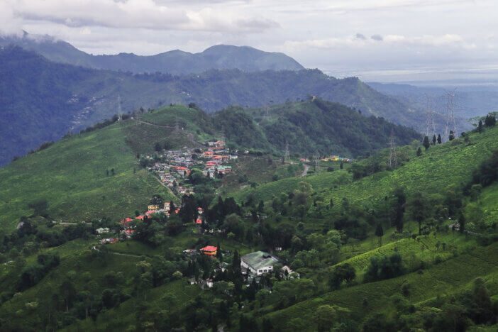 lush green tea garden and mountainscape of himalayan foothills from tingling view point at mirik near darjeeling hill station in west bengal, india