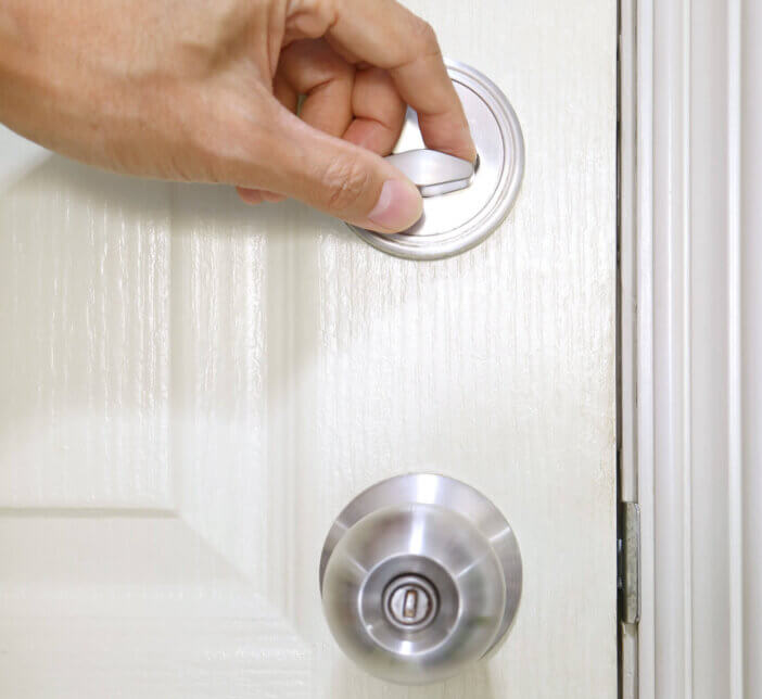 Person closing the door with deadbolt lock