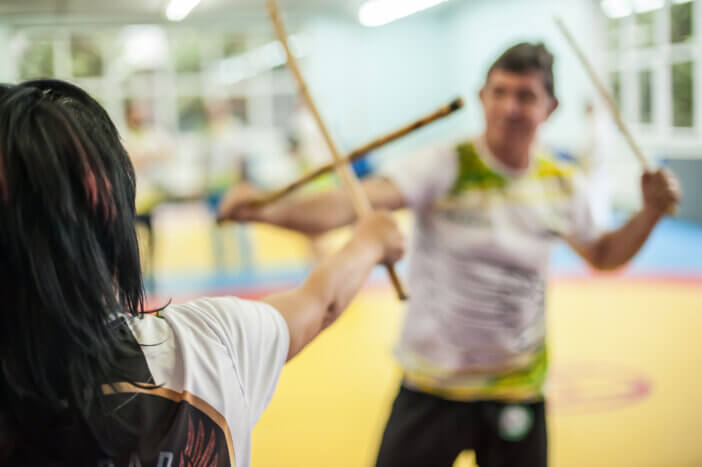 Plovdiv, Bulgaria - December 15, 2018: Female Kapap student practice sticks fighting techniques training on AVI NARDIA KAPAP SELF DEFENSE SEMINAR