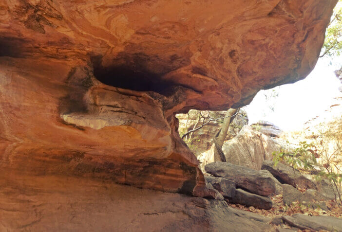 The Bhimbetka rock shelters are an archaeological site in central India that spans the Paleolithic and Mesolithic periods, as well as the historic period. It exhibits the earliest traces of human life in India and evidence of Stone Age starting at the site in Acheulian times.