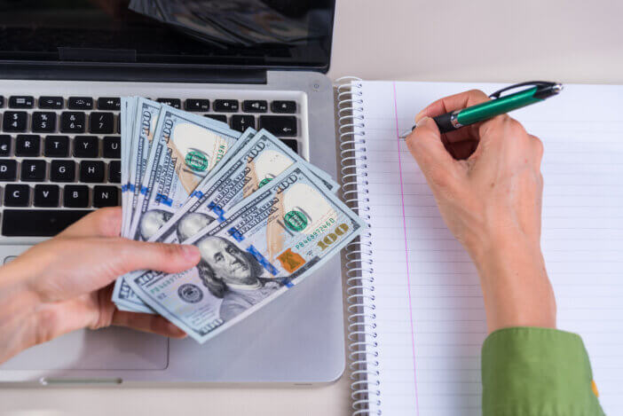 woman's hands holding u.s. dollars, finance, shopping, rise and fall of the dollar