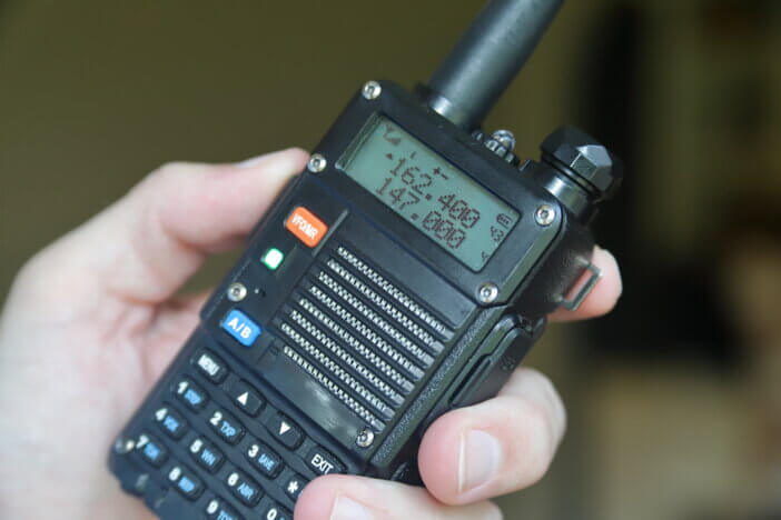 Hand holding two way radio