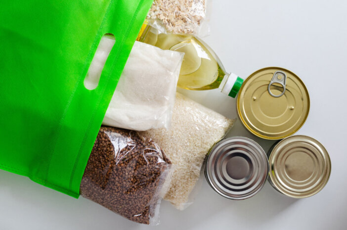 shelf-stable products packaged in a green bag. canned food and cereals. stay at home
