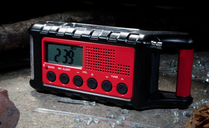 Radio designed for use after a weather emergency with broken glass, bricks and wood