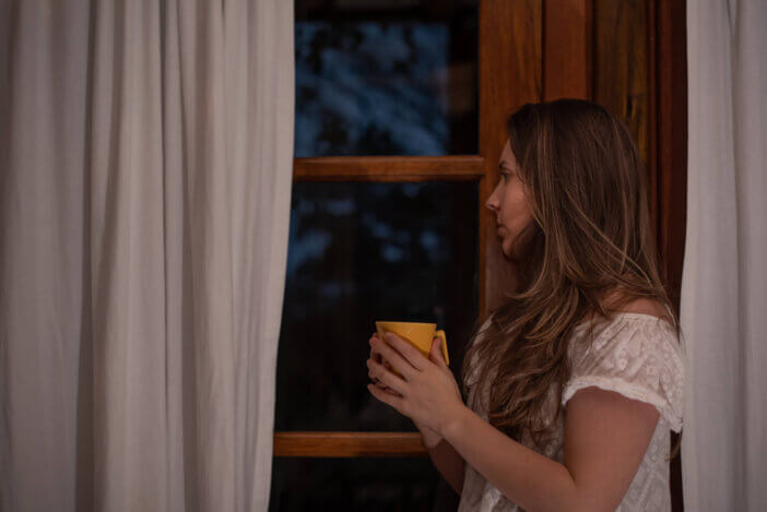 Woman looking through the window