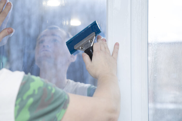 Installation of window film in the office. Protection from ultraviolet radiation.