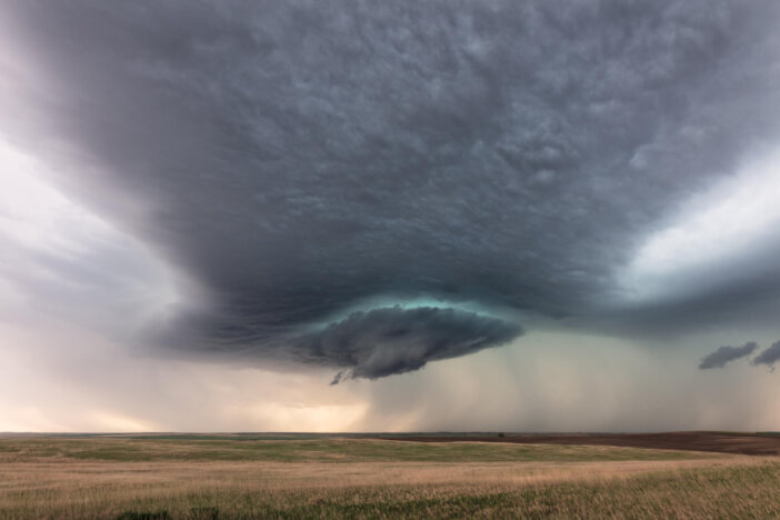 Dramatic storm clouds from a supercell thunderstorm over a field near Sidney, Montana, USA.