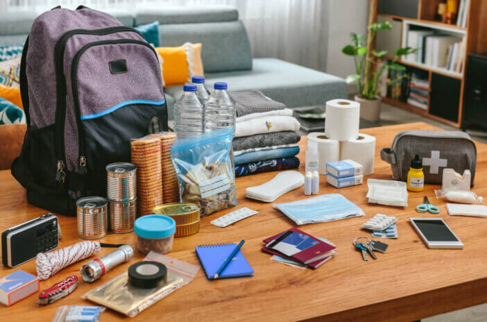 Emergency backpack equipment organized on the table in the living room