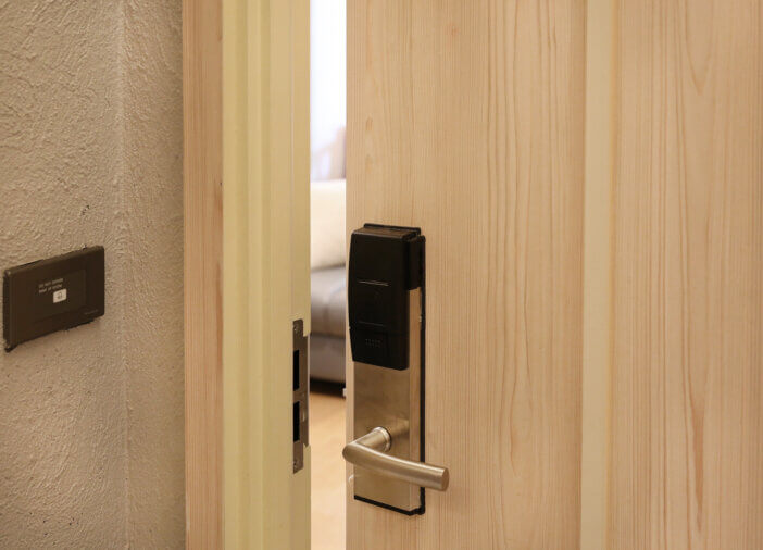 Half open door of hotel room.