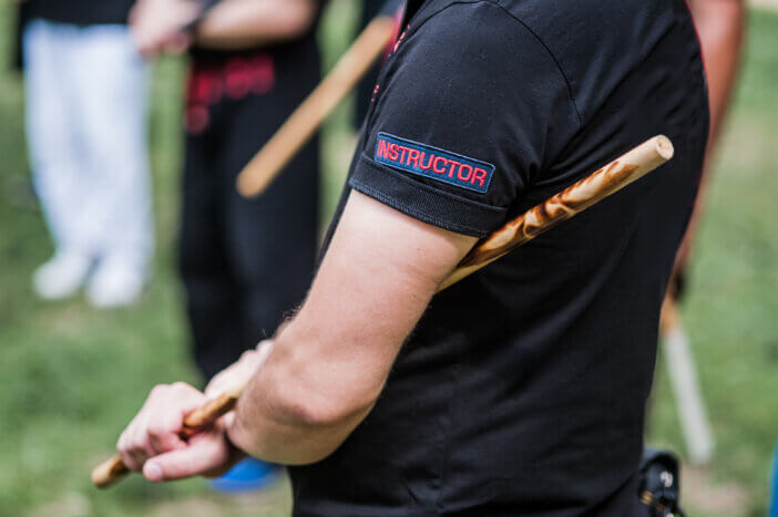 Close-up detail view of filipino escrima arnis instructor holding kali fighting bamboo stick