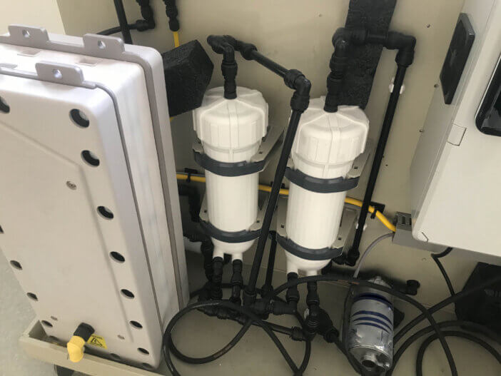 White industrial cylindrical professional replaceable filters for water purification with ion exchange resin.