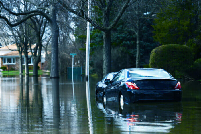 Flooded Compact Cars on Side of the Street. Nature Distasters Photo Collection.