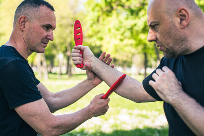 Knife vs knife fight combat training. Sumbrada training method. Plastic weapon defend demonstration drill