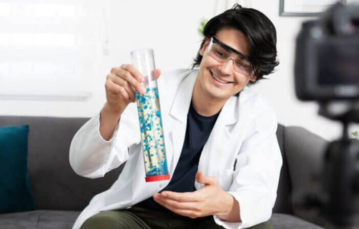 Portrait of a cool science teacher creating a lava lamp for his students on an online video