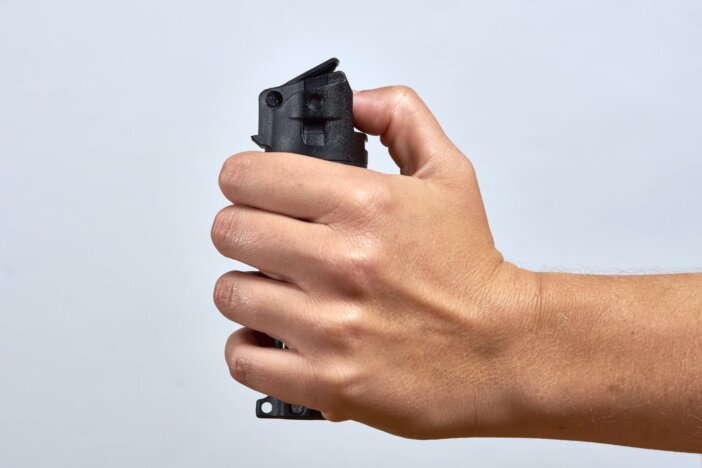 woman aiming pepper spray for defense