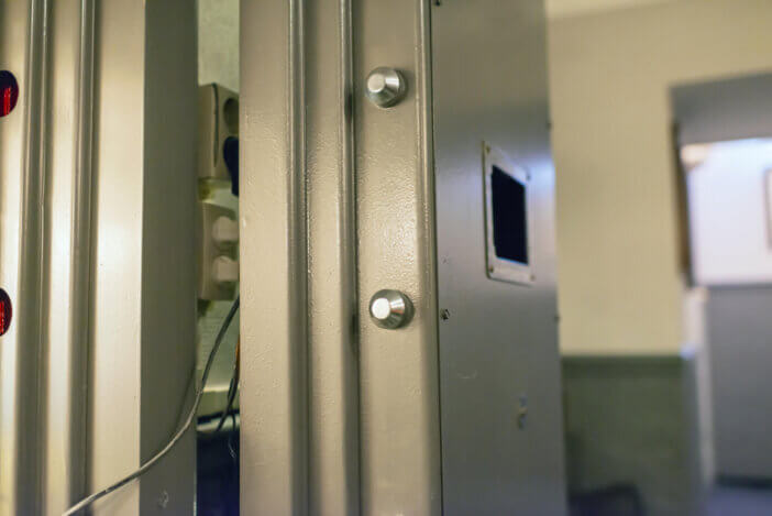 Opened old-fashioned solid vault door of a bank.