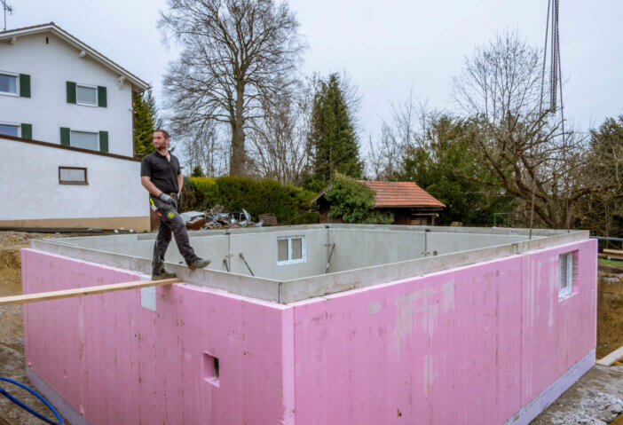 Prefabricated house, workers in setting up the basement walls on building site, Bavaria, Germany, Europe, April 03, 2016