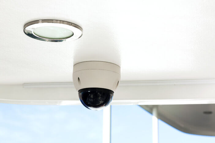 CCTV camera on the hull of an expensive motor yacht. CCTV camera white on a white body.