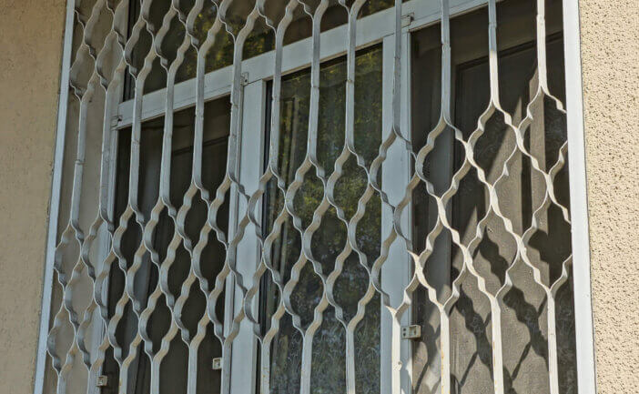 one big one with an iron grate on a brown wall