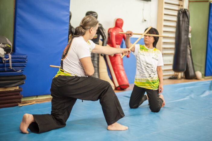 Plovdiv, Bulgaria - December 15, 2018: Female Kapap student practice sticks fighting techniques training on AVI NARDIA KAPAP SELF DEFENSE SEMINAR