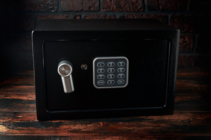 Steel Safe, Safety box or modern electronic locker on wooden background.