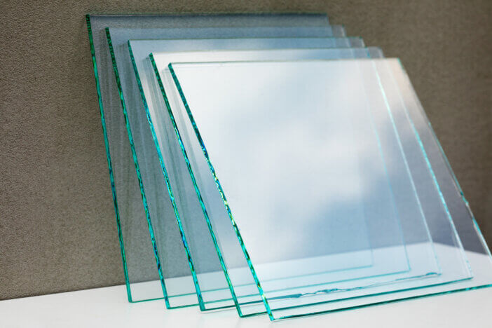 Sheets of Factory manufacturing tempered clear float glass panels cut to size.