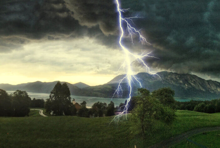 Thunderstorm with lightning strikes over the Alps at Lake Attersee, Salzburg Austria, Concept for insurance damage, security, severe weather and climate change