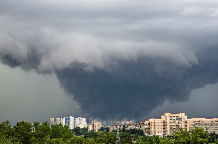 Huge wide powerful catastrophic tornado in a densely populated city power on a scale of F3, EF4-5