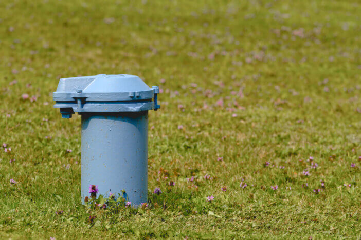 Blue water well pipe and cap.