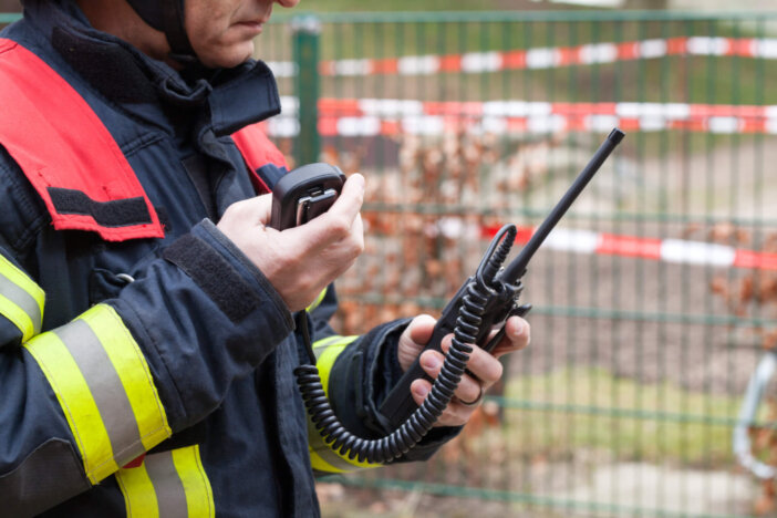 Firefighter in action with walkie takie in the hand